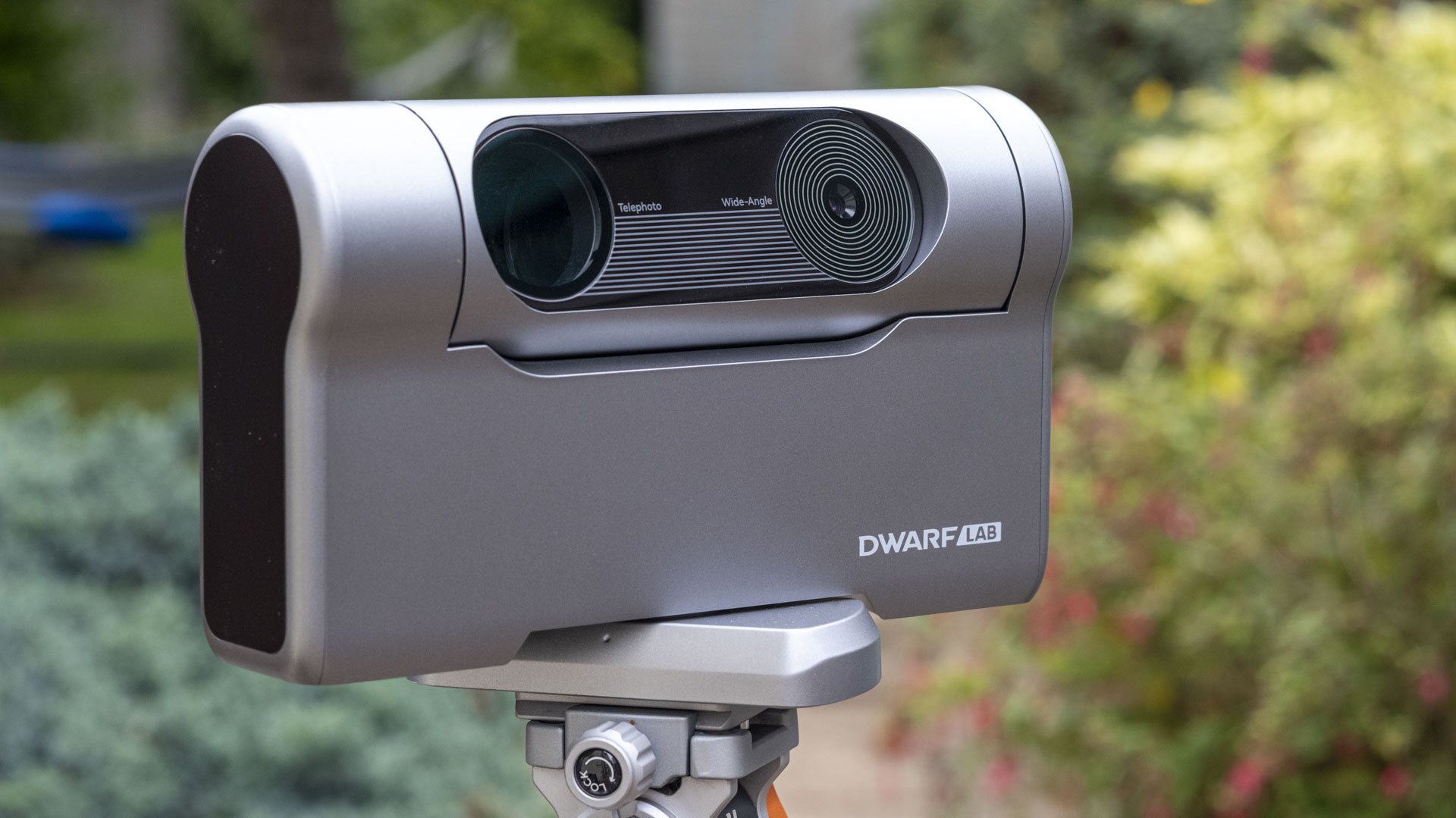 The Dwarf III smart telescope photographed in a garden, showing the front of the device