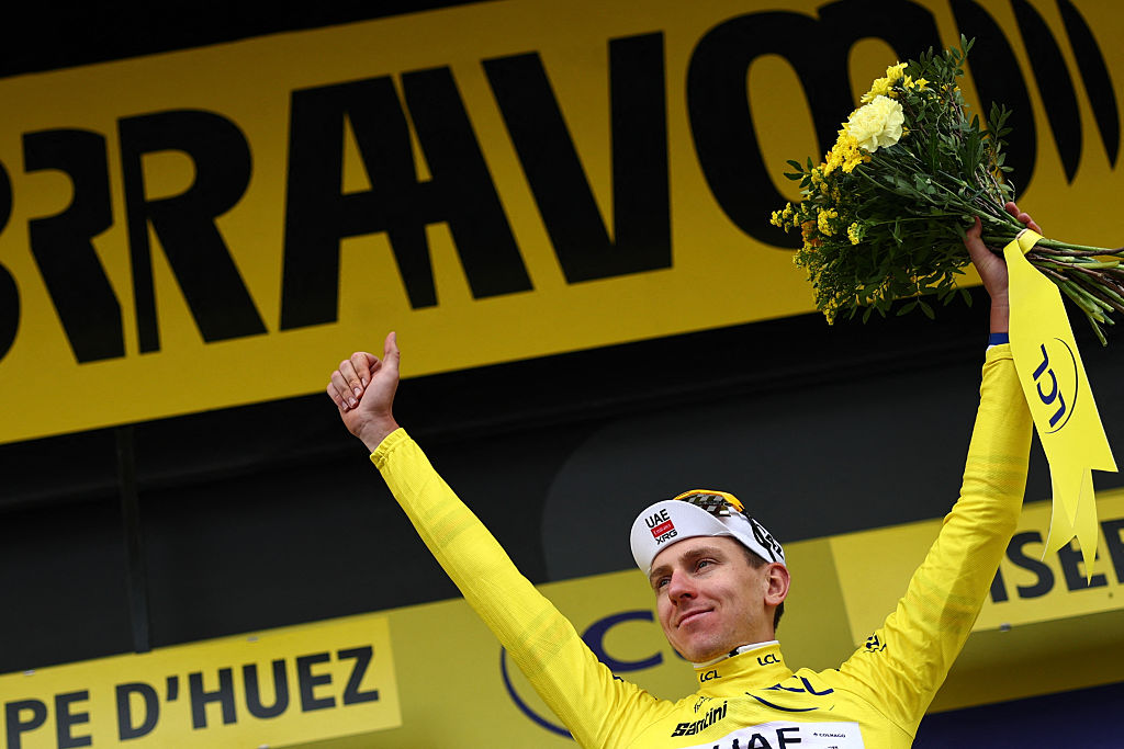 UAE Team Emirates - XRG's Slovenian rider Tadej Pogacar celebrates on the podium with the overall leader's yellow jersey after the 20th stage of the 113th edition of the Tour de France cycling race, 170,9 km between Le Bourg-d'Oisans and Alpe d'Huez in the French Alps, on July 25, 2026. (Photo by Anne-Christine POUJOULAT / AFP)