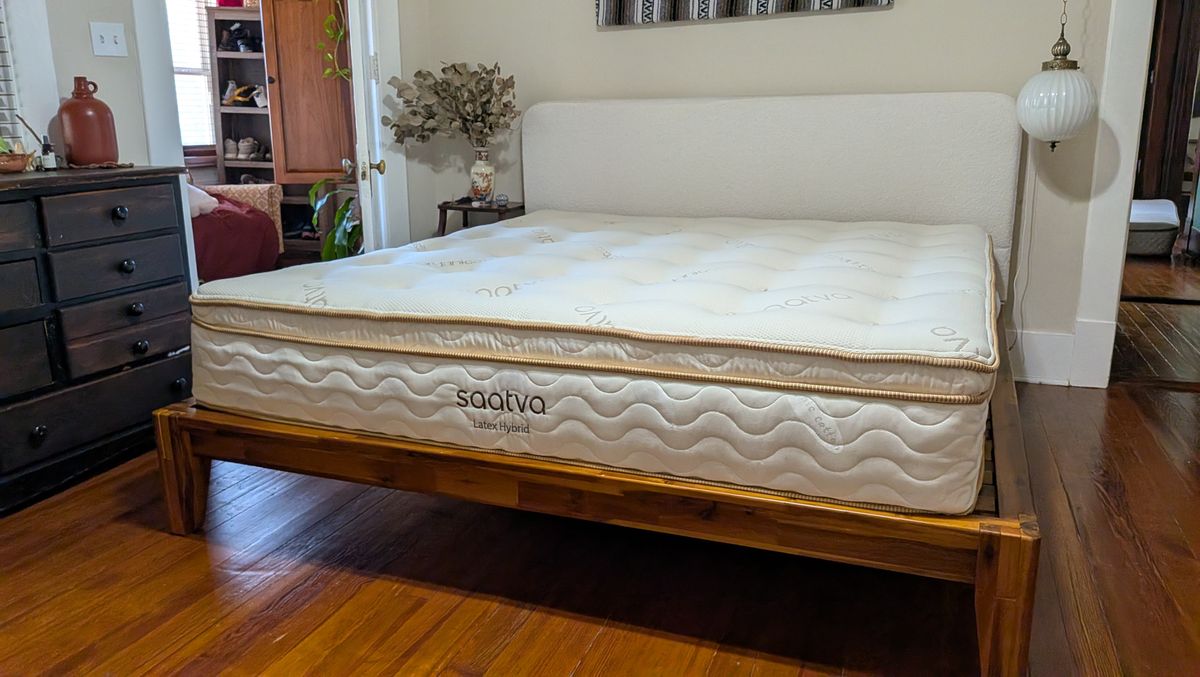 Saatva Latex Hybrid Mattress feature review, with a queen-size undressed Saatva Latex Hybrid Mattress in tester Alex's bedroom