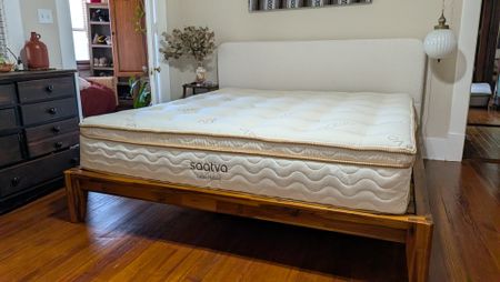 Saatva Latex Hybrid Mattress feature review, with a queen-size undressed Saatva Latex Hybrid Mattress in tester Alex's bedroom