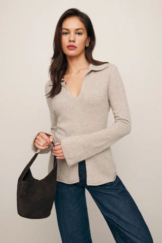 reformation winter sale woman wearing cashmere jumper with collar and split hem detail