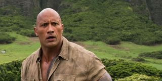The Rock stands outside in a scene from Jumanji