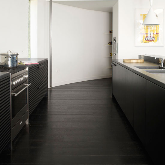 Kitchen with white walls and wooden flooring