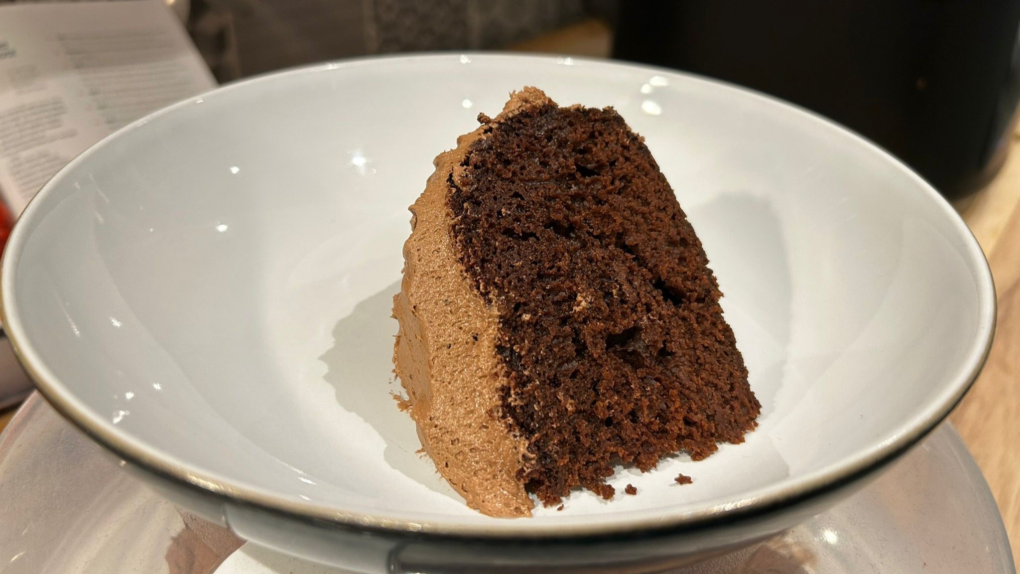 Slice of frosted chocolate cake baked using Cosori 5L Rice Cooker