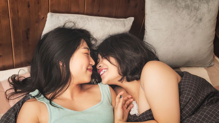couple laughing in bed - stock photo