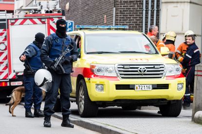 Police raid a Brussels neighborhood.
