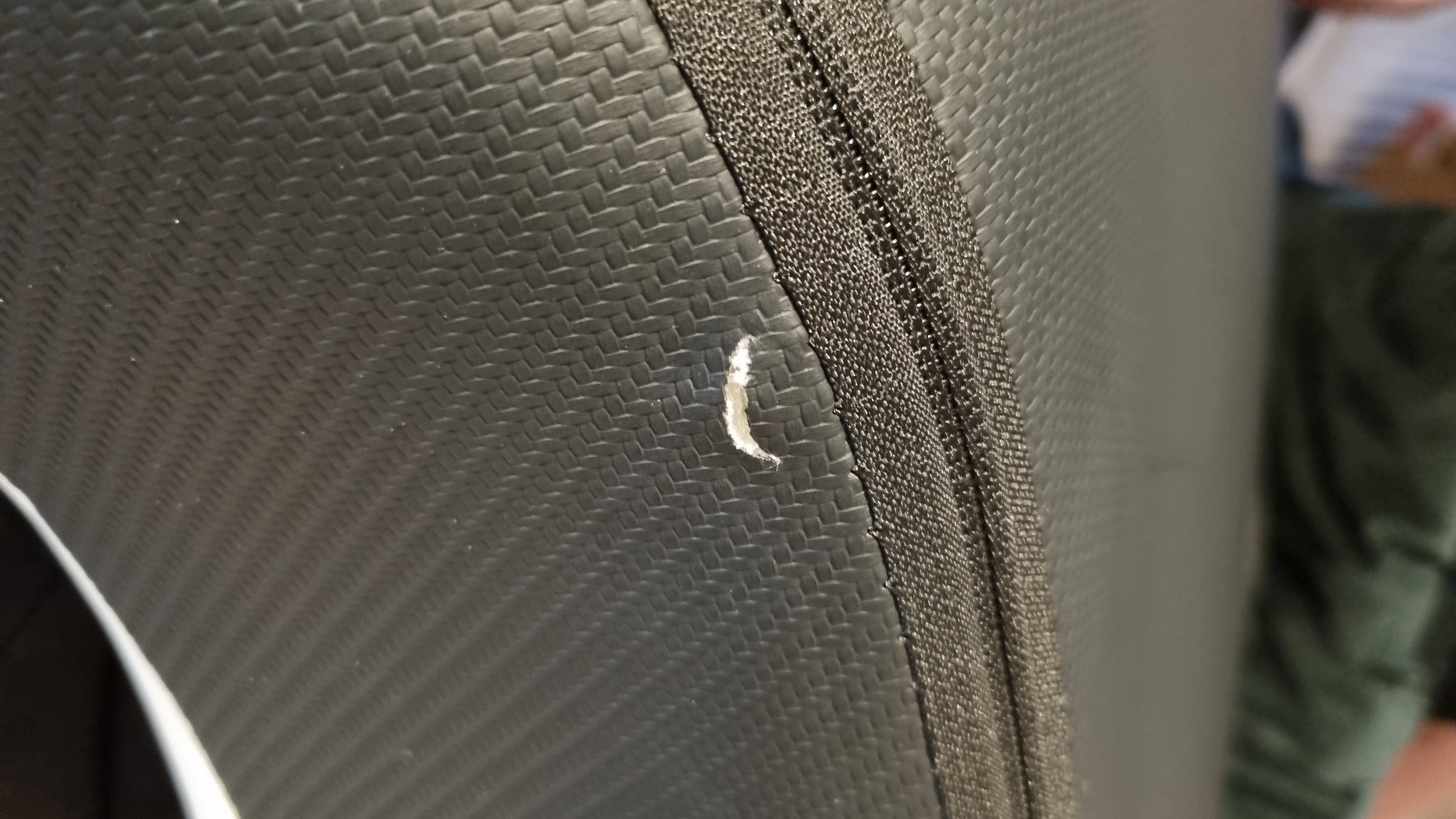 A small nick in the material of the rear backing of the AndaSeat Kaiser 4 XL