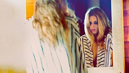 Blonde woman and mirror