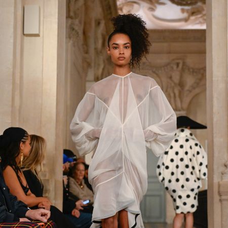 a model walks the runway wearing side a ponytail