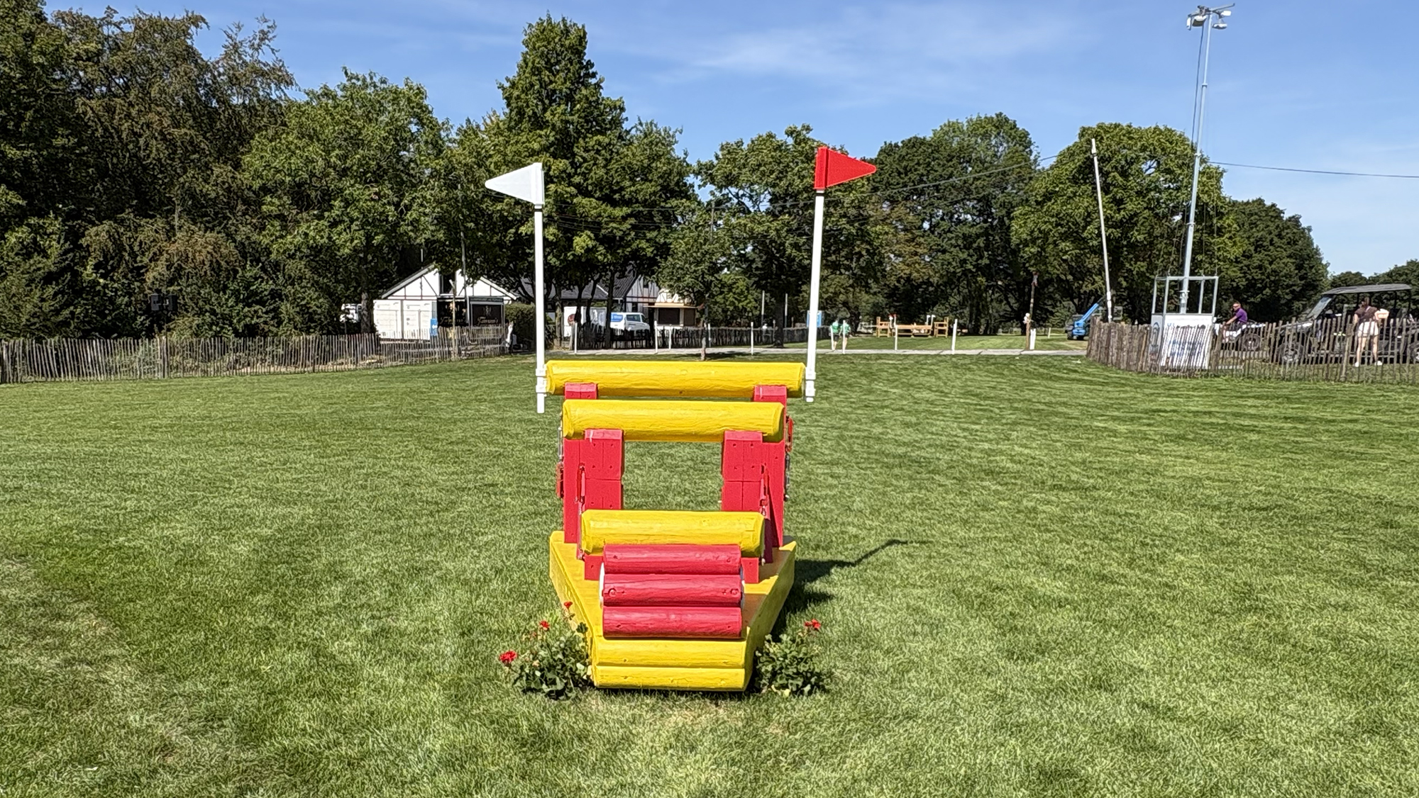 A triple bar arrowhead, painted yellow and red, on the Aachen eventing World Championships cross-country course