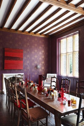 elegant dining hall with beams wooden tables and chairs and purple wallpaper