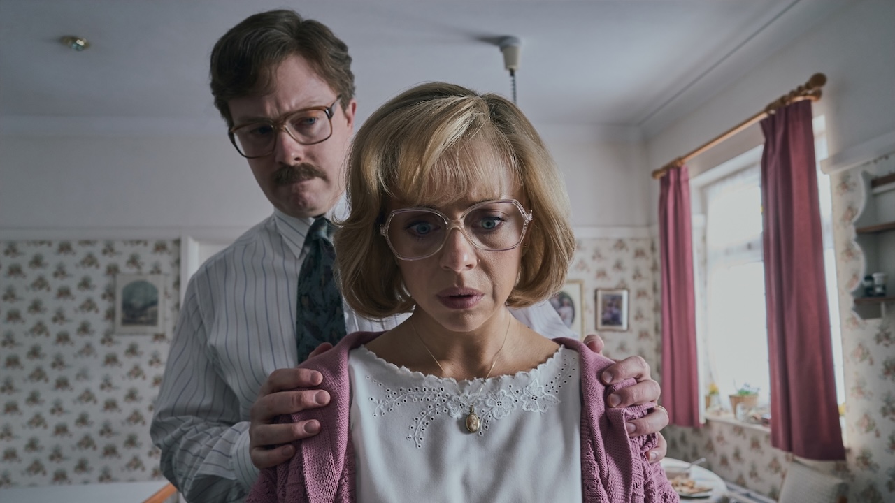 Aunt Petunia and Uncle Vernon Dursley looking at Harry's letter in HBO's Harry Potter TV show