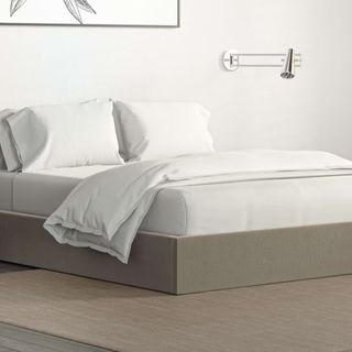 Halle Storage Platform Queen Bed with white bedding against a white wall.