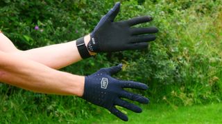 A pair of 100% Sling gloves being worn