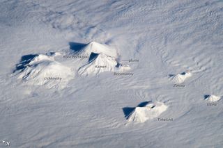 Astronauts aboard the International Space Station captured this oblique view of the snow covered peaks of the volcanoes on Russia's Kamchatka Peninsula, home to many active volcanoes.