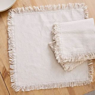 Dunelm white linen napkins with frayed edge.