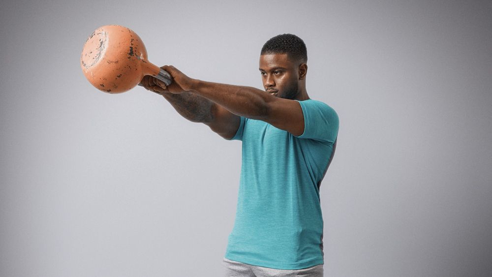 Man performing kettlebell swing