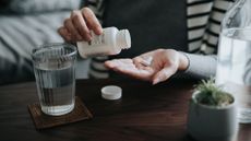 Someone with a supplement in their hand