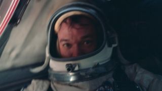 Astronaut Michael Collins is in a spacesuit inside of a spacecraft during NASA's Gemini 10 mission.