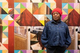 Artist Sonia Boyce standing in front of her art piece, "Feeling Her Way", at the British Pavilion