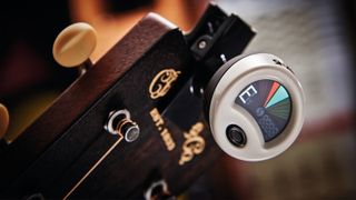 Snark clip-on guitar tuner on the headstock of a Martin guitar