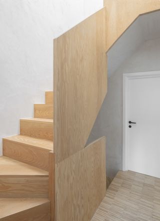 Douglas Fir staircase leading up past white walls