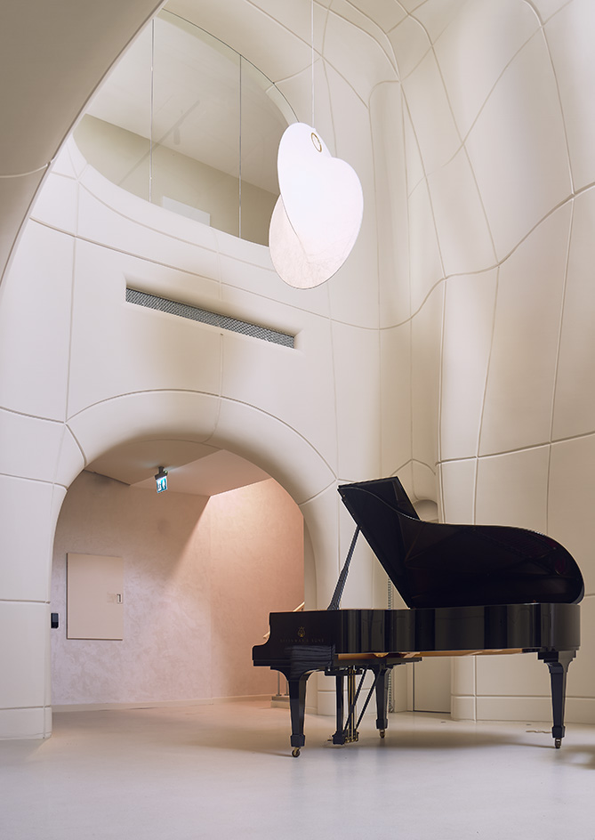 views of Pur residential recording studio, a family of structures in a cluster, made of stone and wood against blue mediterranean skies