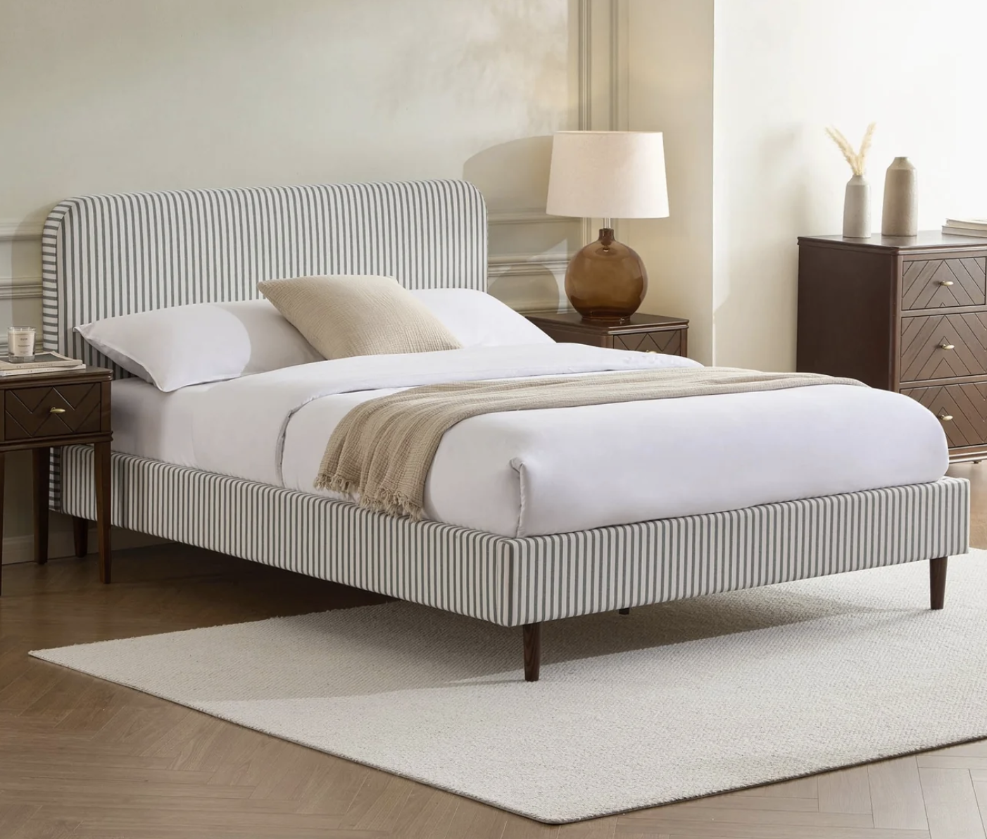 gray and white striped bed in a neutral living room