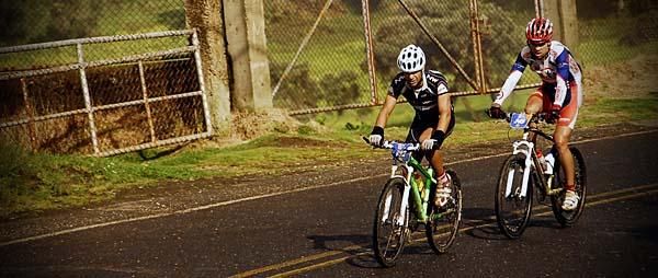A pair of riders on a road section.