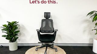 Desky Pro Plus Ergonomic Chair standing on a circular mat against a white wall