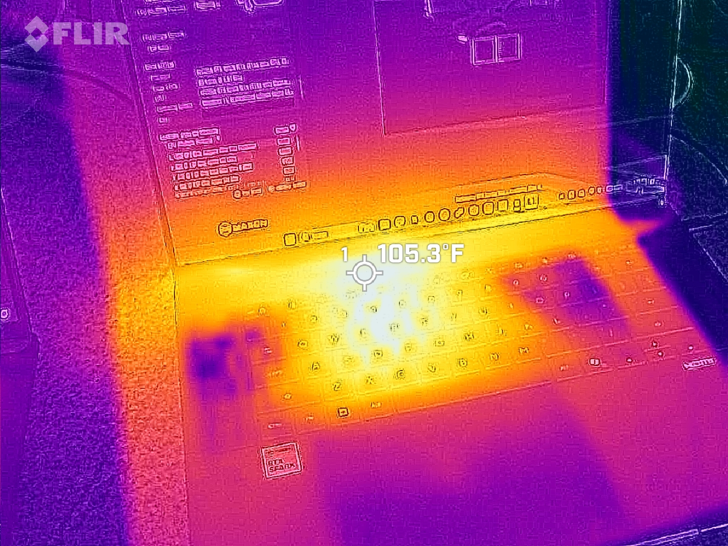 FLIR thermal image of the ASUS ProArt P16 keyboard deck during operation, showing heat concentration in bright yellow and orange with a center point reading 105.3&amp;deg;F.
