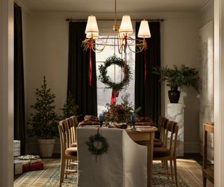 A Christmas table decorated with seasonal greenery