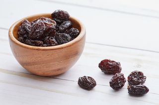 Image shows a bowl of raisins.