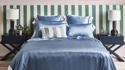 silk sheets on bed with striped headboard