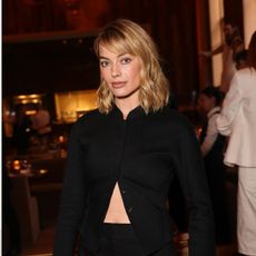 An image of Margot Robbie wearing culottes with court heels