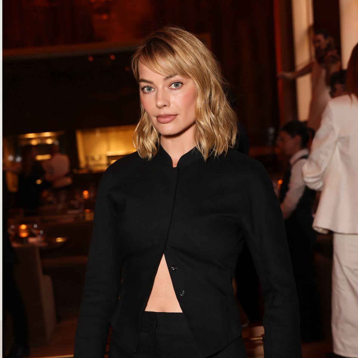 An image of Margot Robbie wearing culottes with court heels