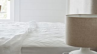 A white, quilted mattress protector from The White Company.