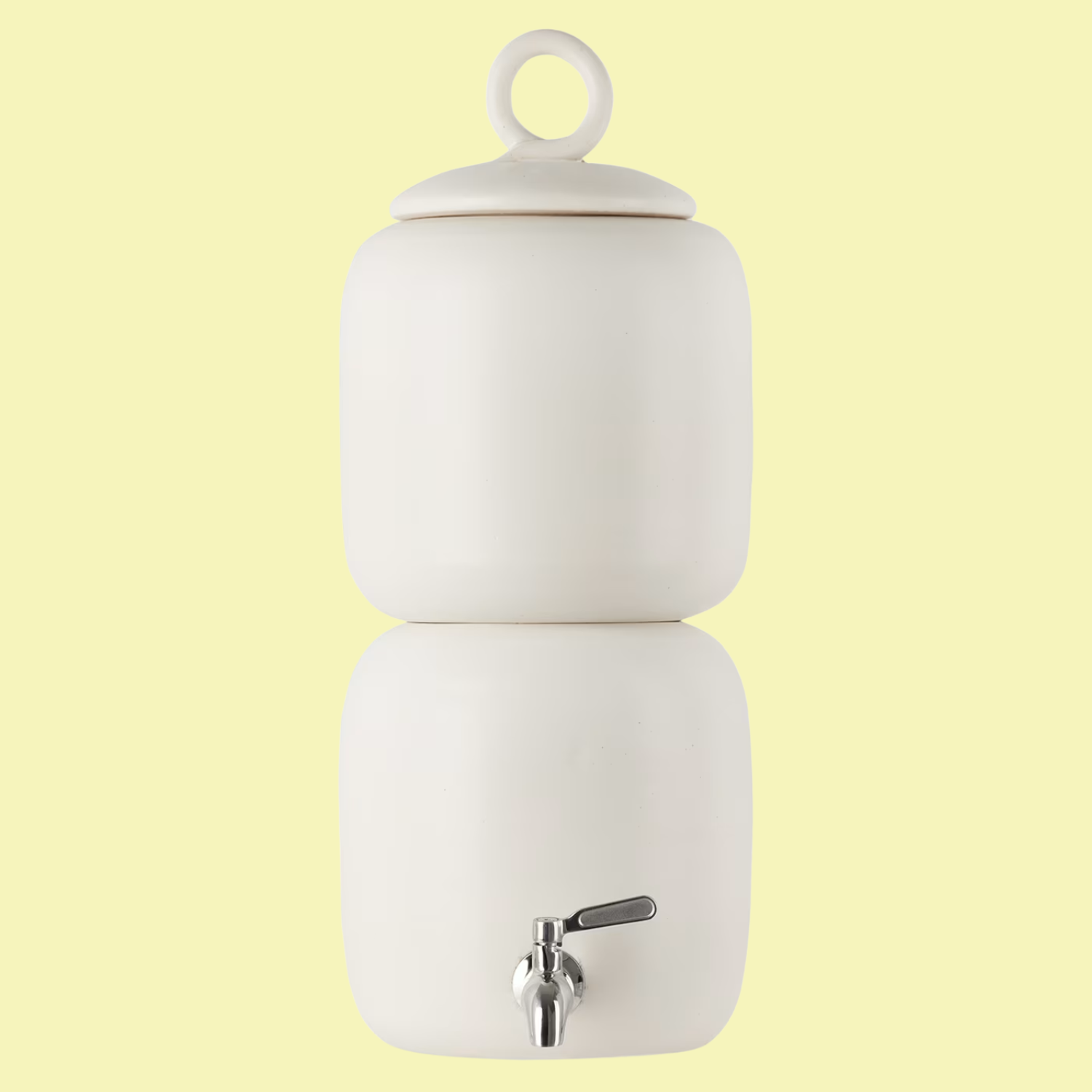 A white ceramic water dispenser against a pastel yellow backdrop