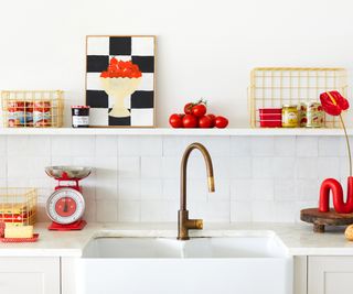 kitchen sink area in white with red and yellow accessories