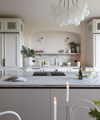A white kitchen with detailed cabinets
