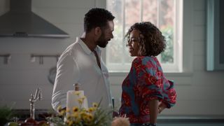 Dion Johnstone as Erik Whitley and Heather Headley as Helen Decatur smiling at each other in a kitchen in sweet magnolias season 4