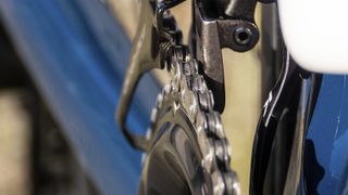 A close up of a Shimano 12-sped chain on an 11-speed crank with a K-Edge chain keeper