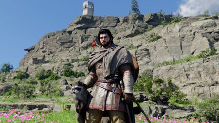 Kliff standing by a cliff holding a racoon