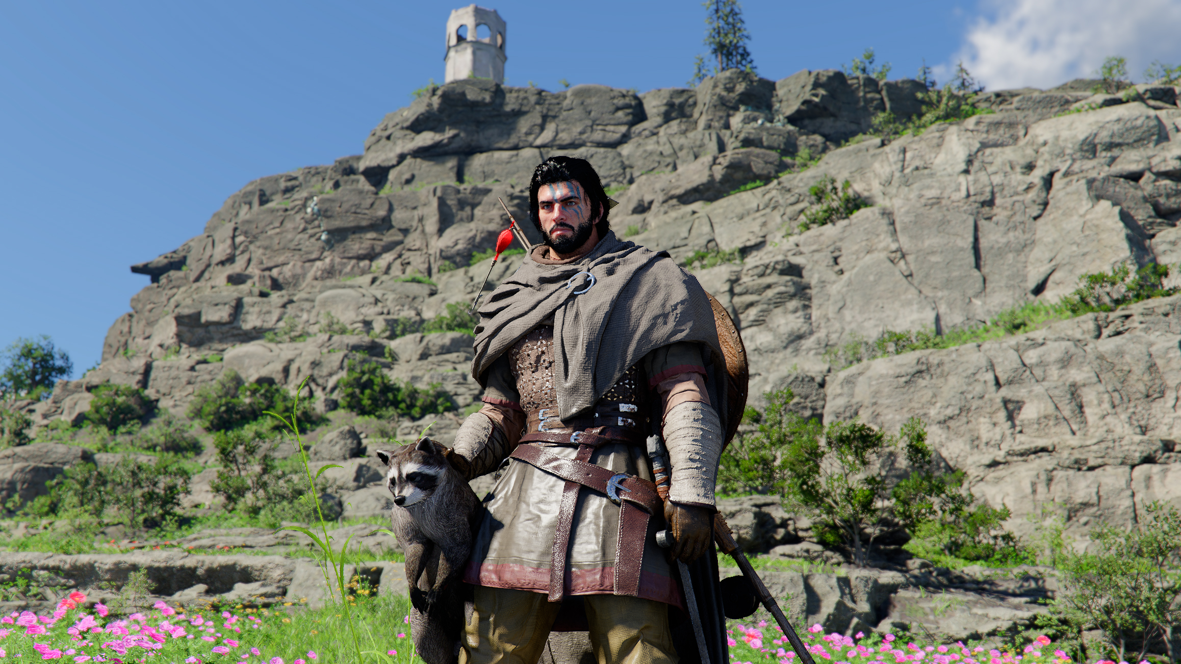 Kliff standing by a cliff holding a racoon