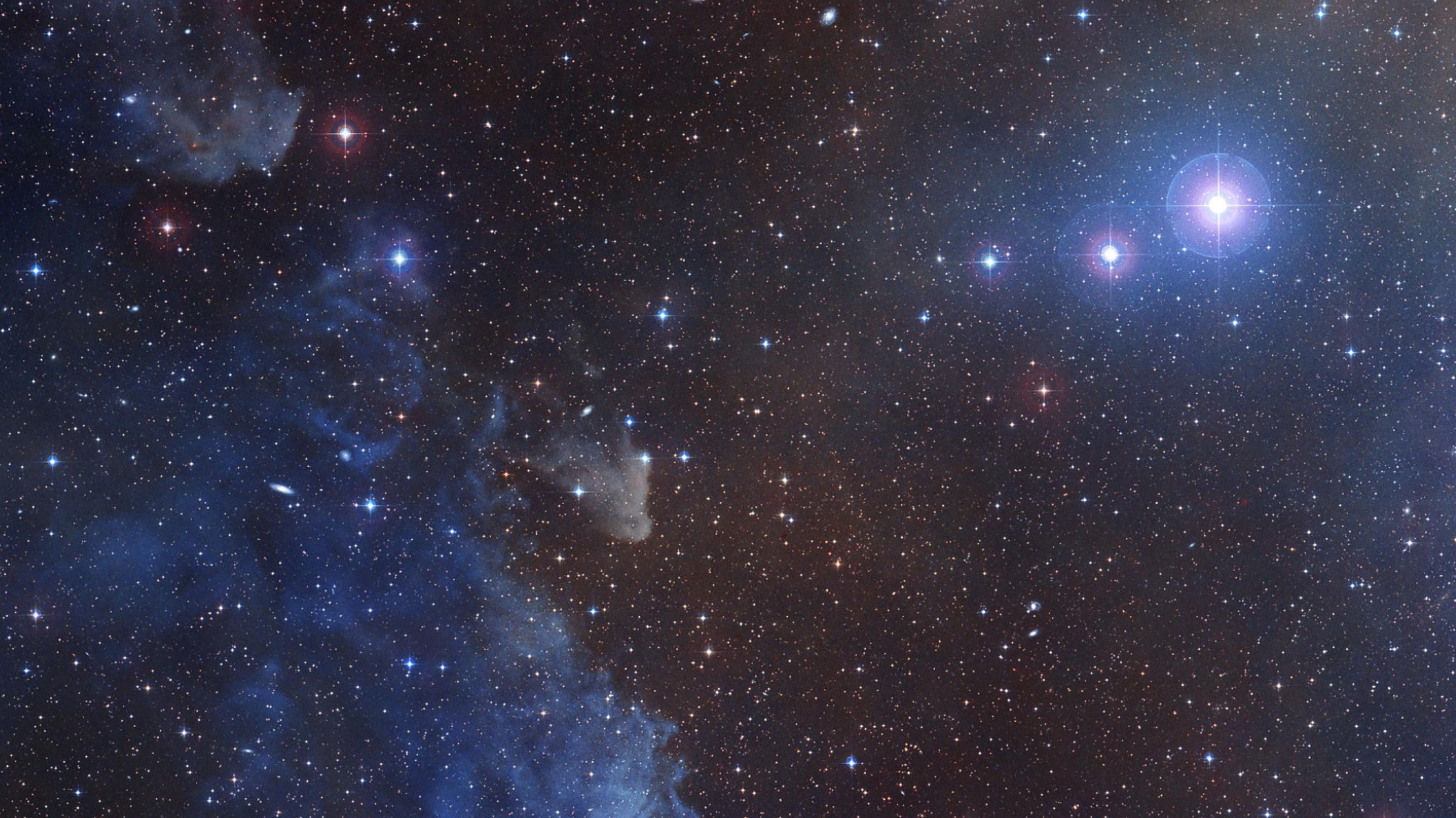 The bright blue star Rigel next to the cosmic clouds of the Witch Head Nebula