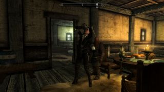 Yennefer from the Witcher drinks a pint inside a Skyrim building