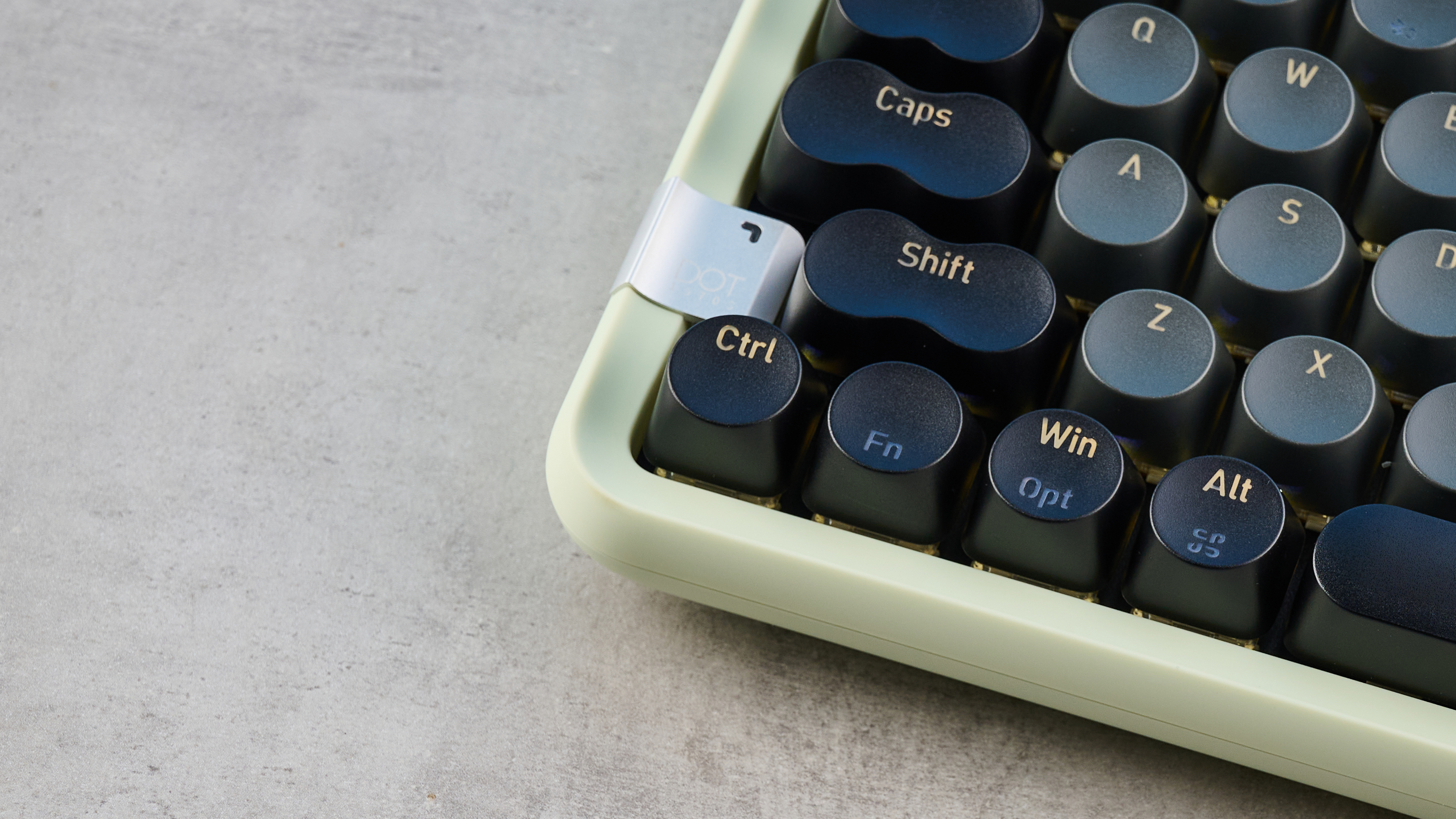The Lofree DOT on a stone surface with its lower left keys showing