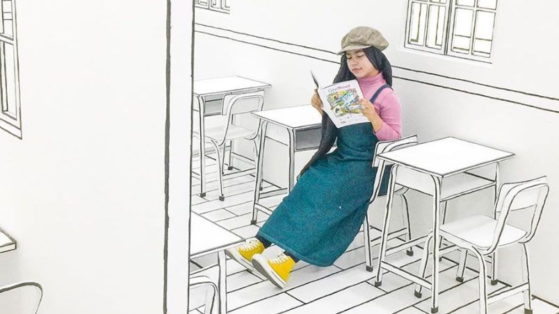 A lady reading a magazine sitting in a 2D cafe