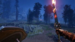 Avowed upgrade weapons and armour - The player character holding a flaming sword in their right hand and a shield in their left, overlooking a wooden area at night.