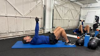 Personal trainer Jay Conroy at Bio-Synergy performing an above the head abdominal crunch